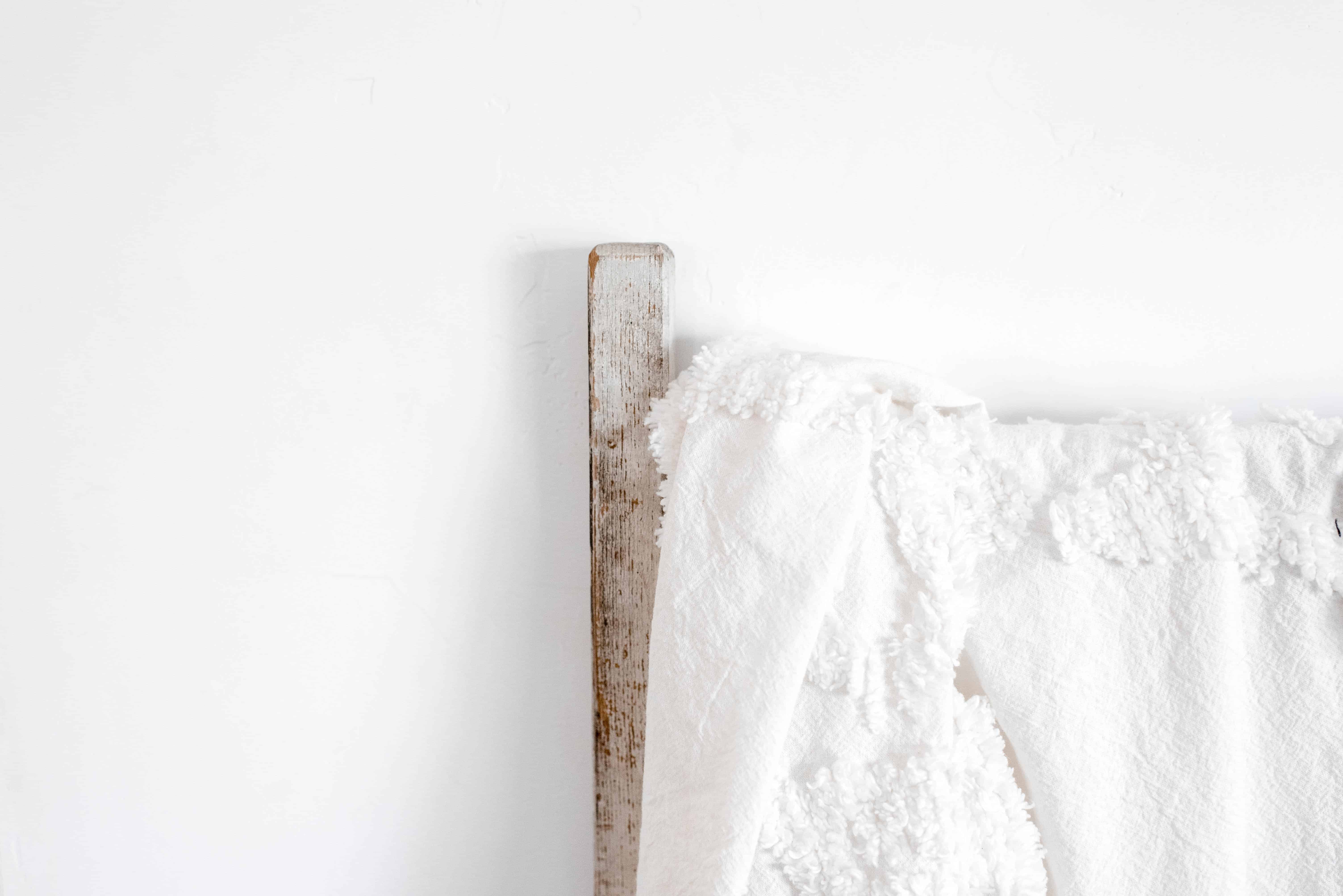 white textured blanket on old ladder