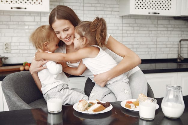 mom and two kids eating snacks