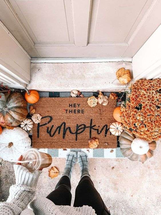 fall front porch with pumpkins and jute rug